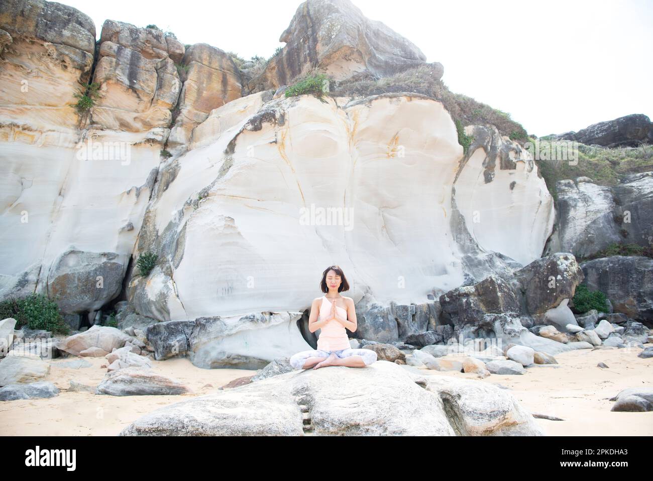 Donna fare yoga sulla spiaggia Foto Stock