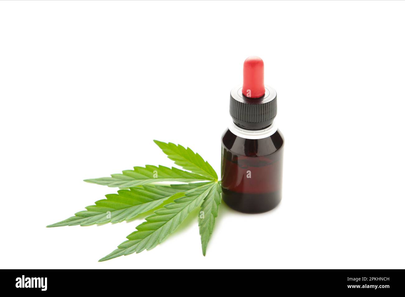 Olio di canapa e foglia di cannabis isolati su sfondo bianco. Olio di cannabis sano. Vista dall'alto Foto Stock