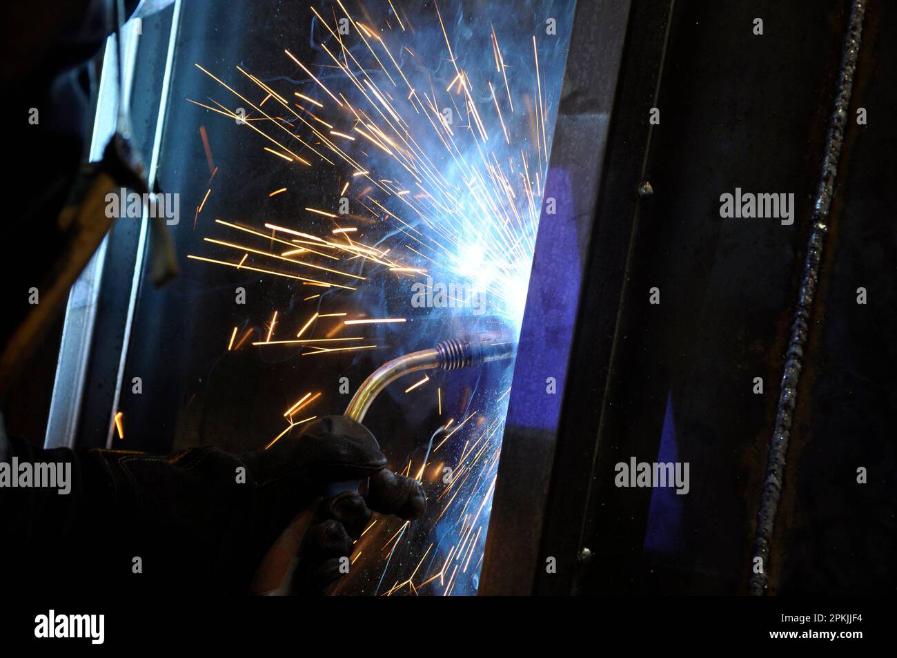 Processo di saldatura. Fabbricazione di strutture metalliche e servizi di riparazione e costruzione secondo il concetto di lavoro manuale. Produzione. Foto Stock
