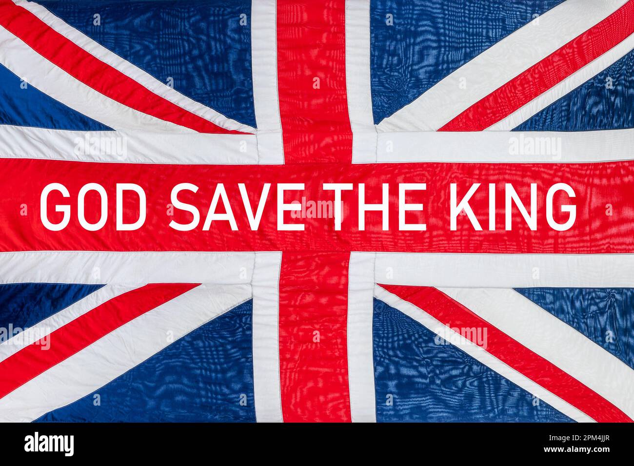 Dio salva il re ha scritto una bandiera britannica, sfondo Union Jack, celebrazione dell'incoronazione del re Charles Foto Stock