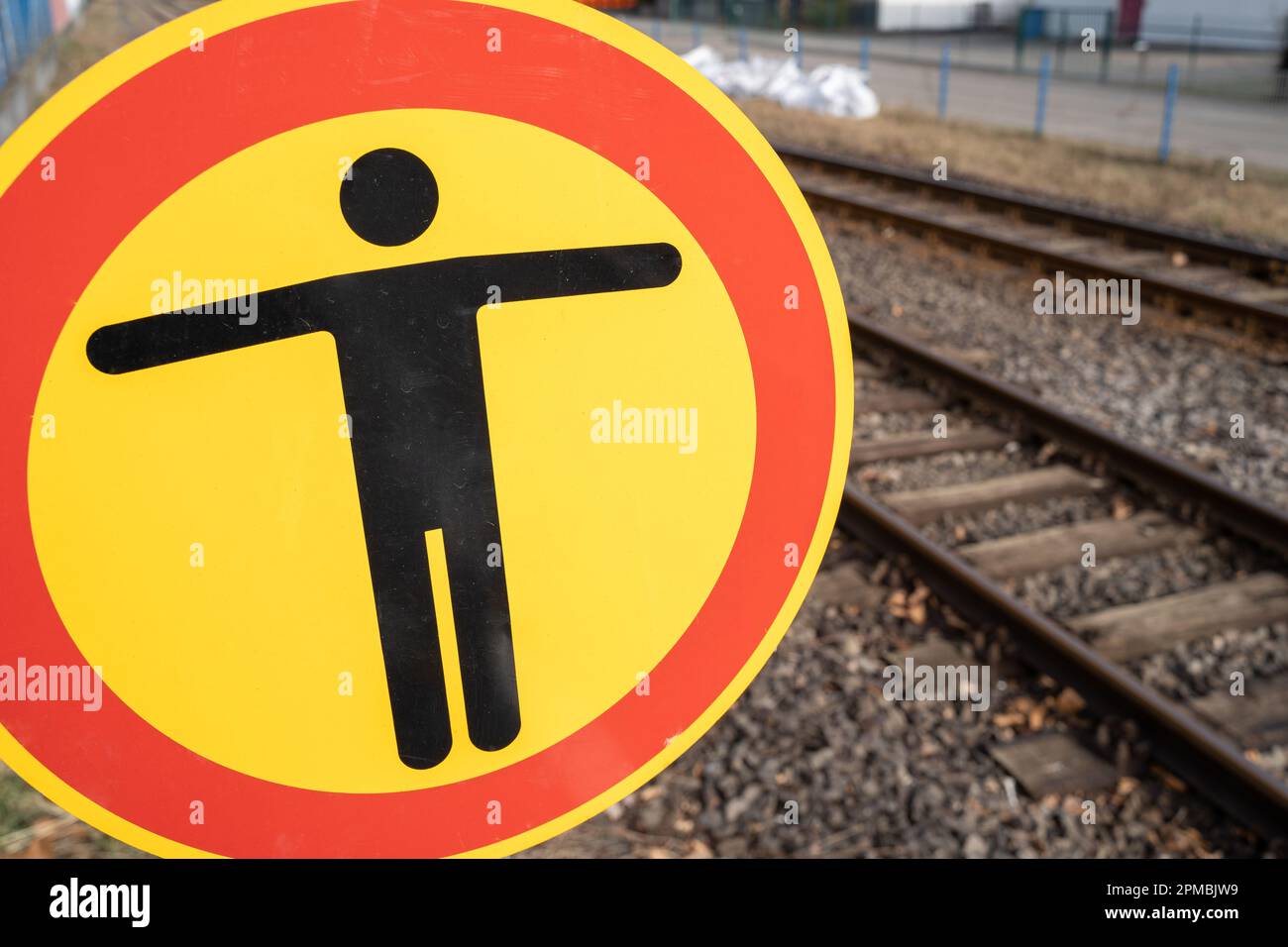 Nessun cartello di passaggio sulla piattaforma ferroviaria con binari sullo sfondo Foto Stock