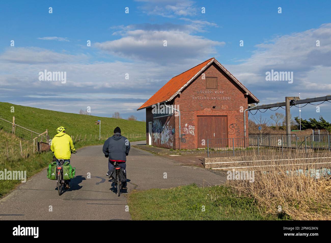 Pista ciclabile, ciclisti, stazione di pompaggio Haselau-Haseldorf, Haselau, Schleswig-Holstein, Germania Foto Stock