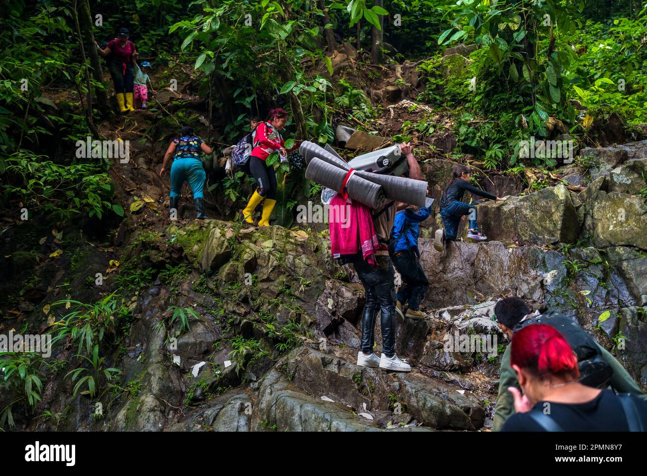 I migranti provenienti dall'Ecuador salgono su un sentiero roccioso nella selvaggia e pericolosa giungla del Darién Gap tra Colombia e Panamá. Foto Stock