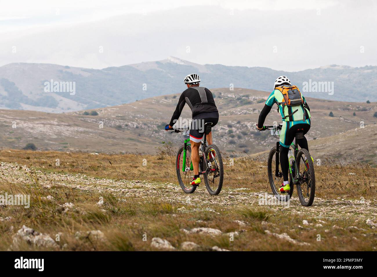 due ciclista maschi in mountain bike sull'altopiano in bicicletta da fondo. zaino sul retro del mountain bike Foto Stock