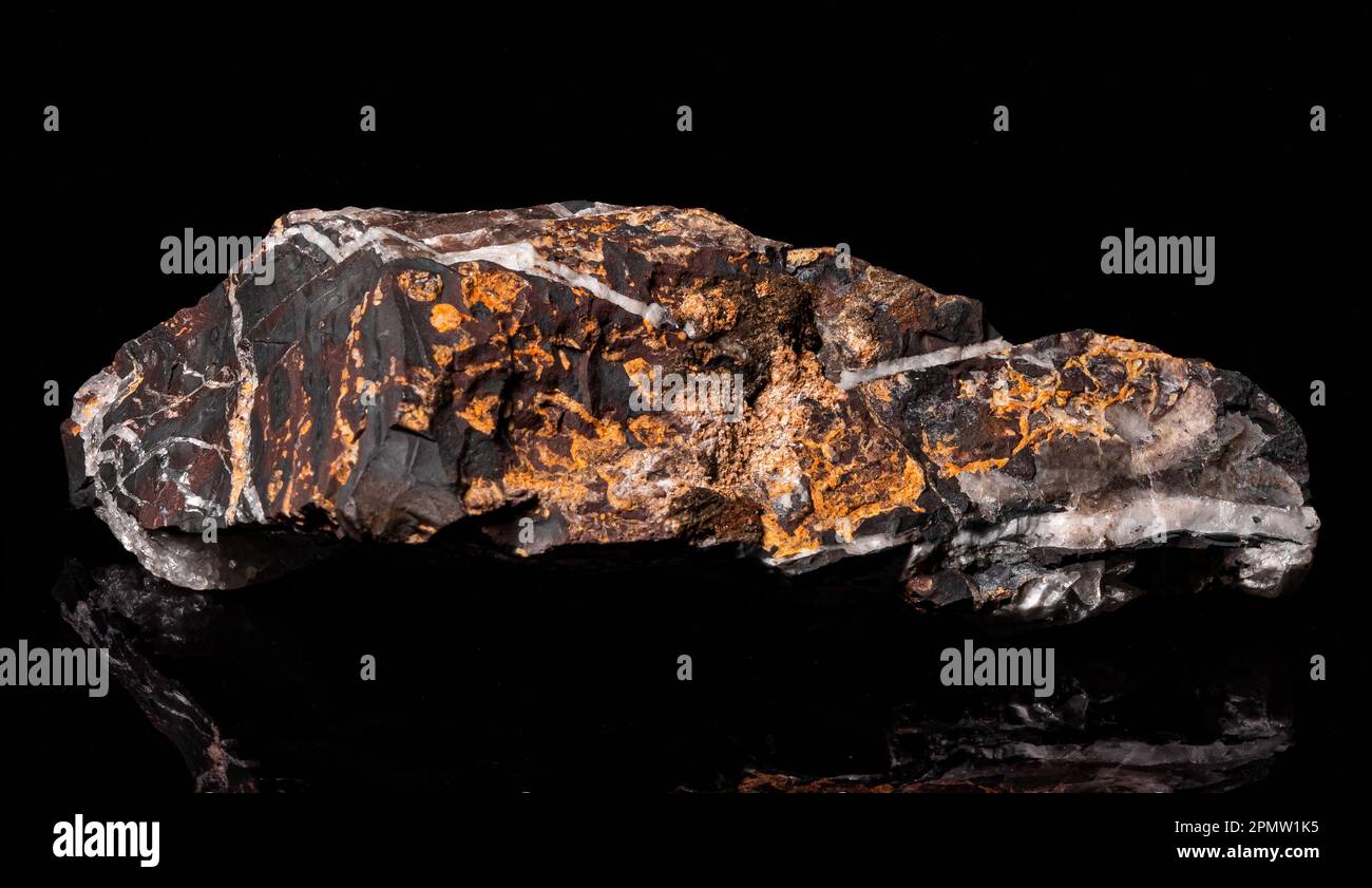 Una roccia minerale con alcune parti cristallizzate su fondo nero Foto Stock