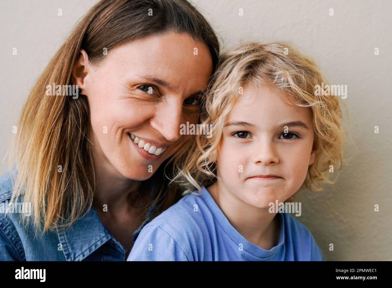Amore per la famiglia - madre felice e figlio bambino sorridente alla fotocamera all'aperto - Focus sul viso del bambino Foto Stock