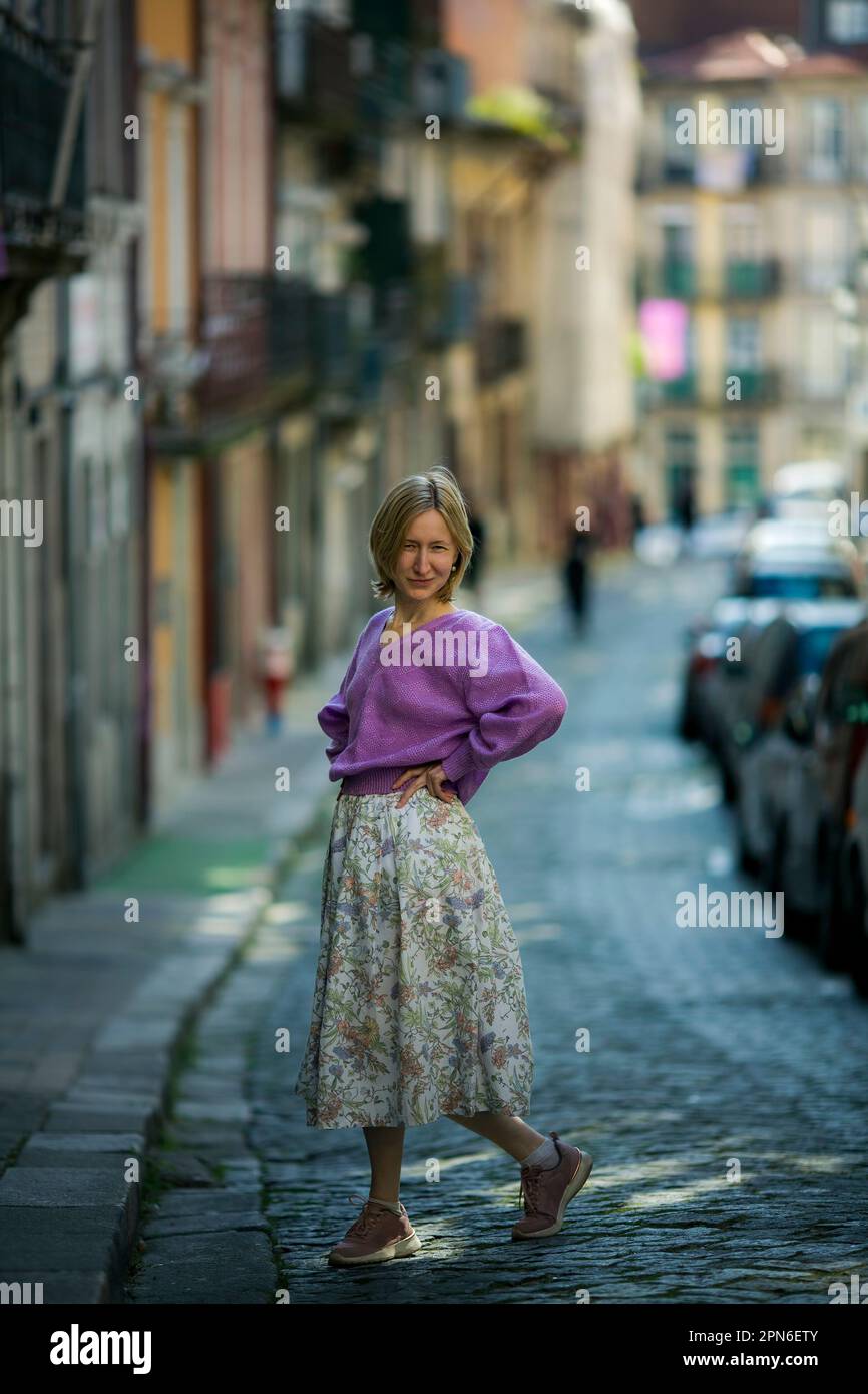 Donna in gonna per le strade del centro di Porto, Portogallo. Foto Stock