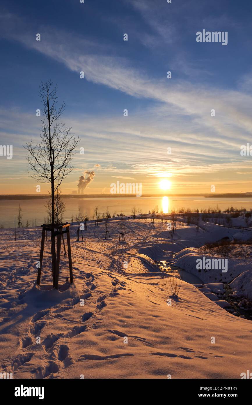 Tramonto in inverno al lago Störmthal. bella sfumatura dal blu all'arancione. passi nella neve. Foto Stock