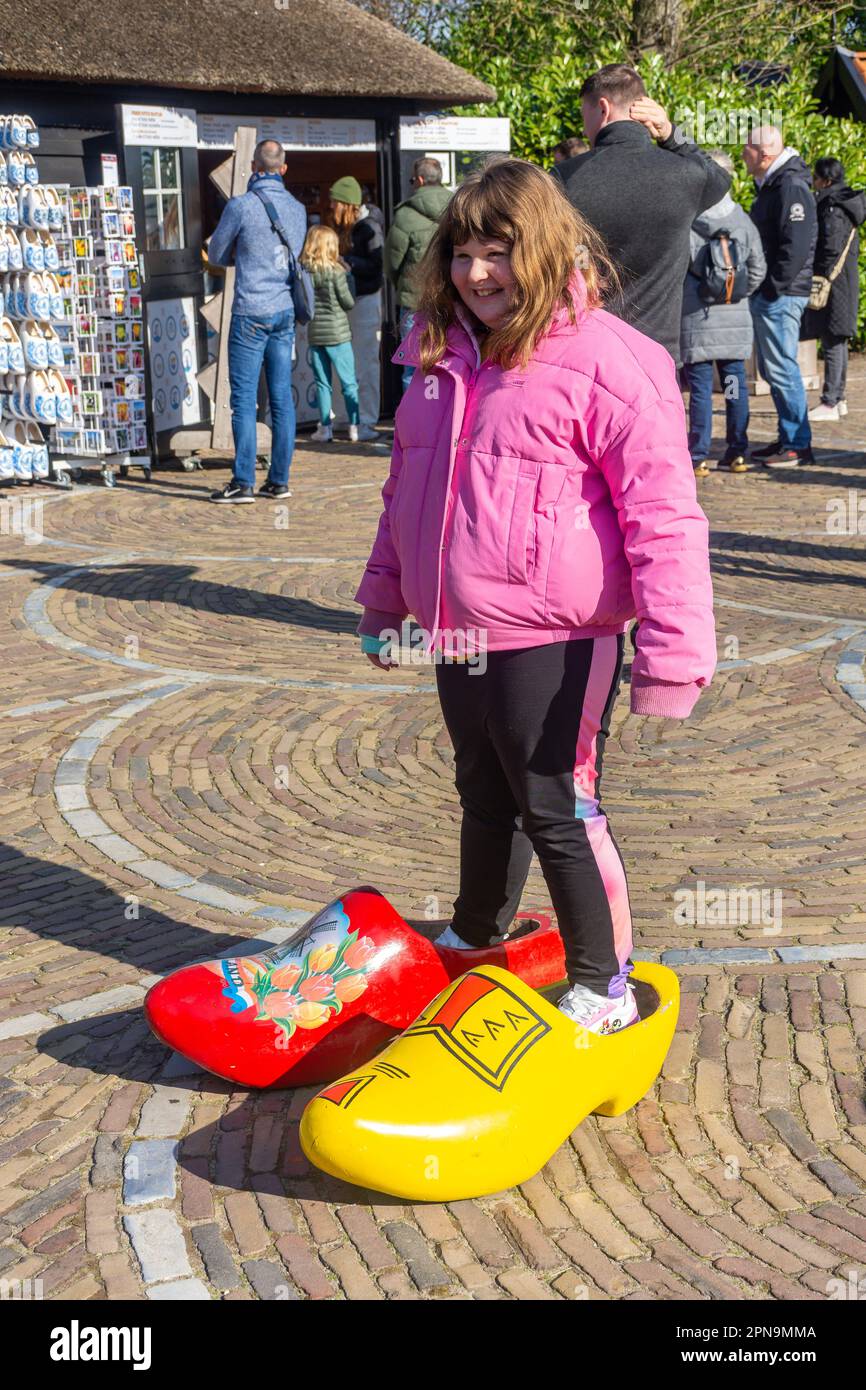 Giovane ragazza in zoccoli giganti, Keukenhof Gardens, Lisse, South Holland (Zuid-Holland), Regno dei Paesi Bassi Foto Stock