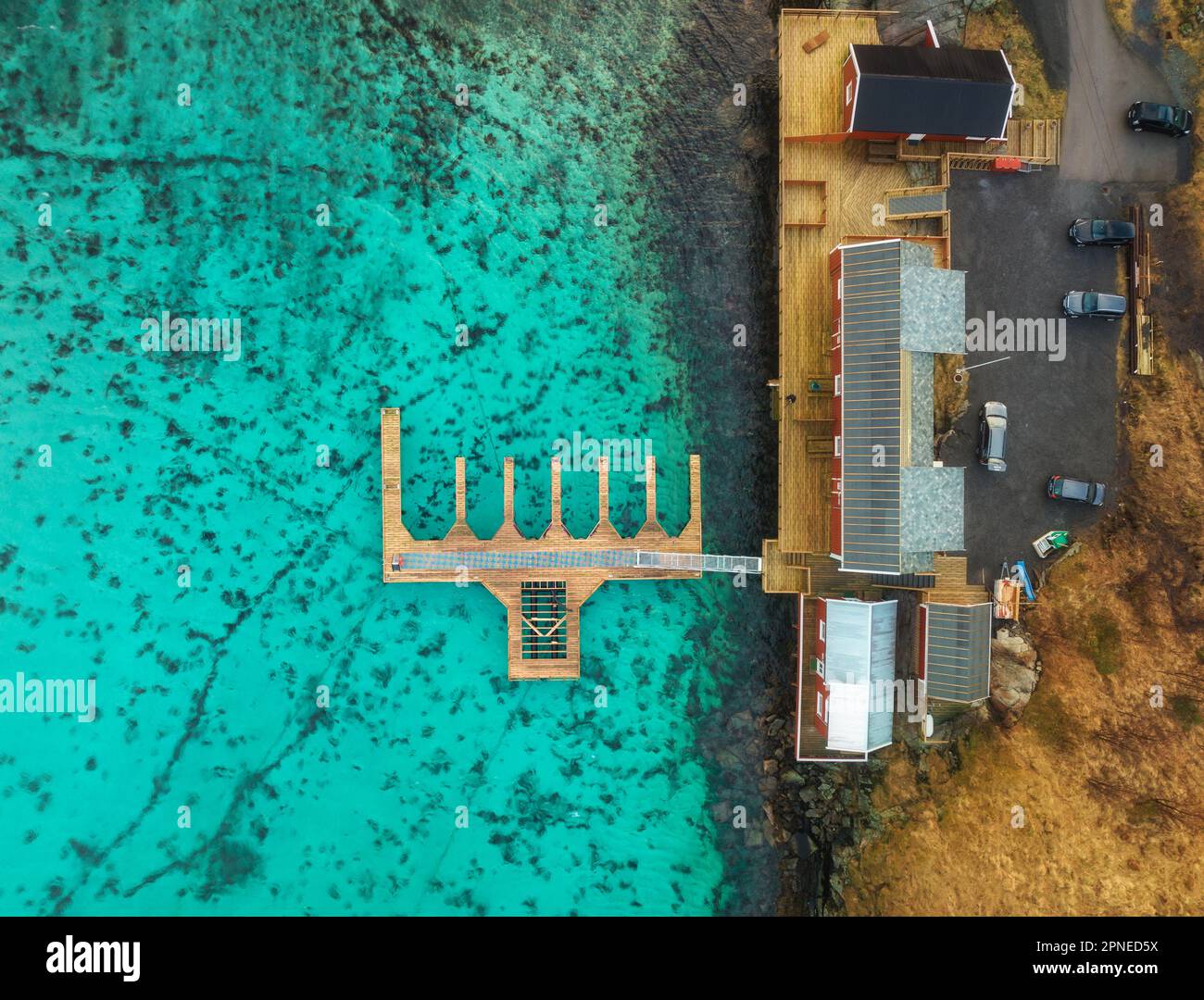 Vista aerea del molo in legno, acqua azzurra, case sulla costa del mare Foto Stock