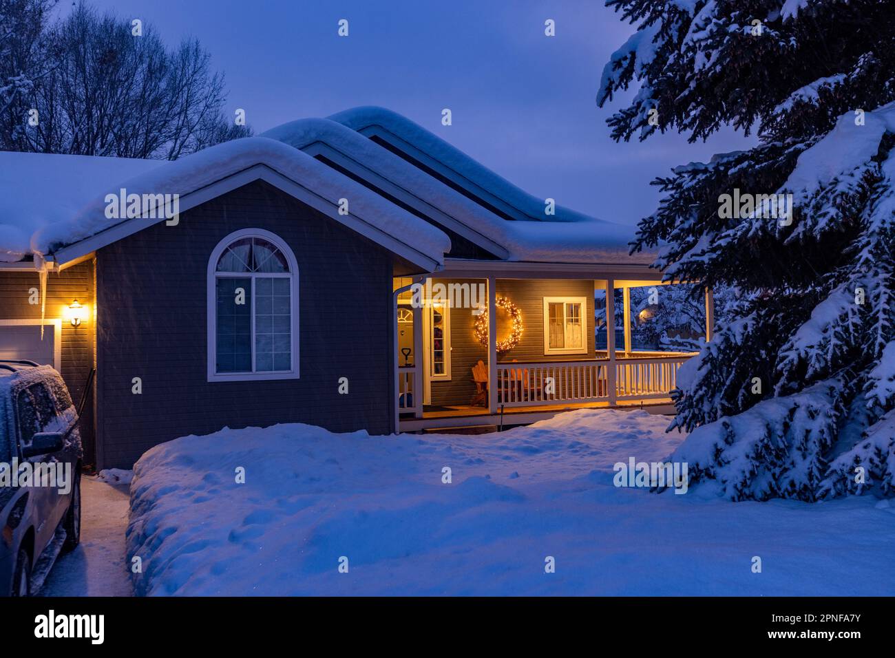 Stati Uniti, Idaho, Bellevue, neve casa coperta con luci portico Foto Stock