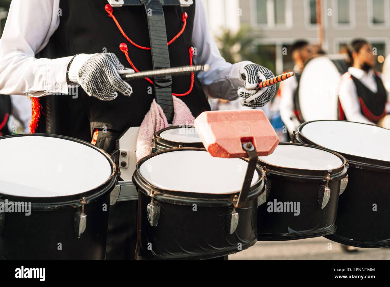 Mani di una persona che suona in una banda marching. Foto Stock