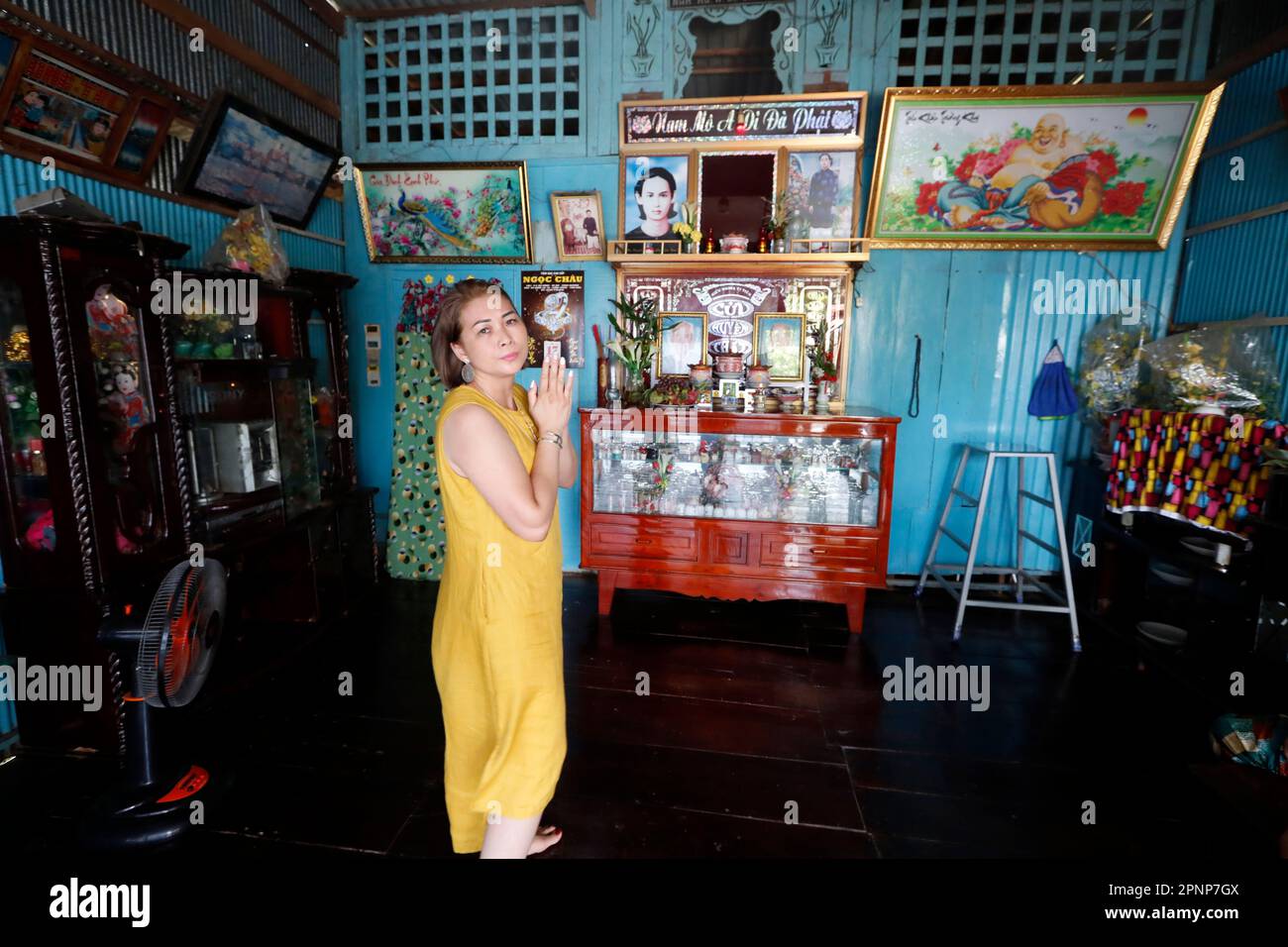 Altare antenato. La venerazione dei morti in casa. Donna che prega. Donna. Tan Chau. Vietnam. Foto Stock