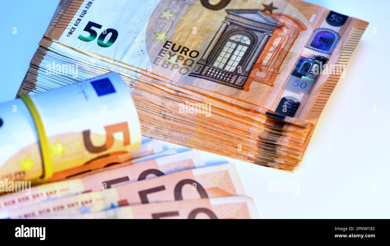 Concetto di molti euro: Un mucchio di banconote da 50 euro arrotolate su uno sfondo bianco per migliaia di euro in banconote da 50 euro Foto Stock