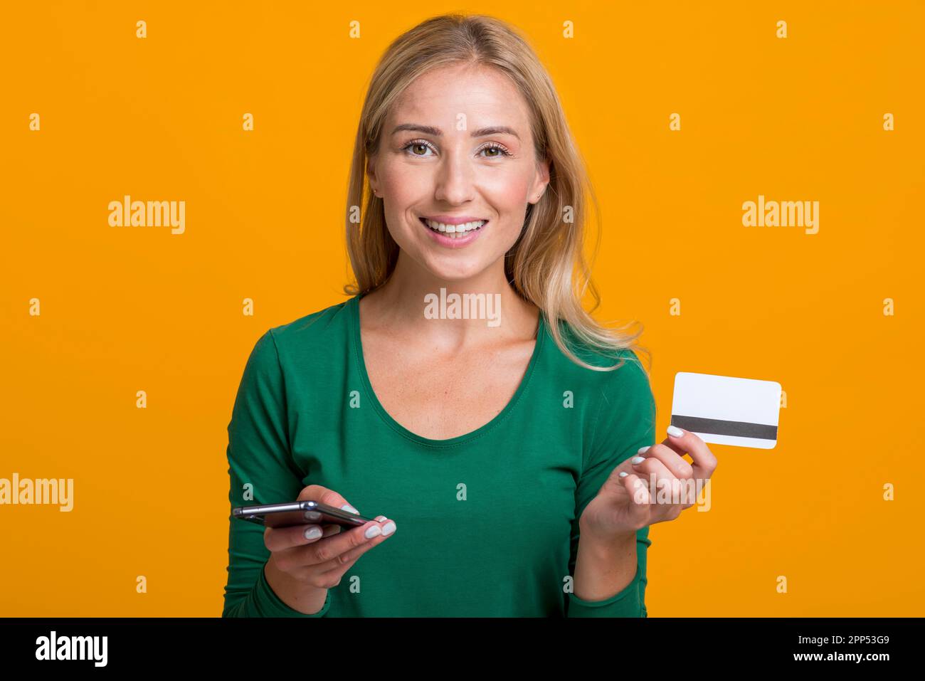 Donna sorridente con carta di credito per smartphone Foto Stock