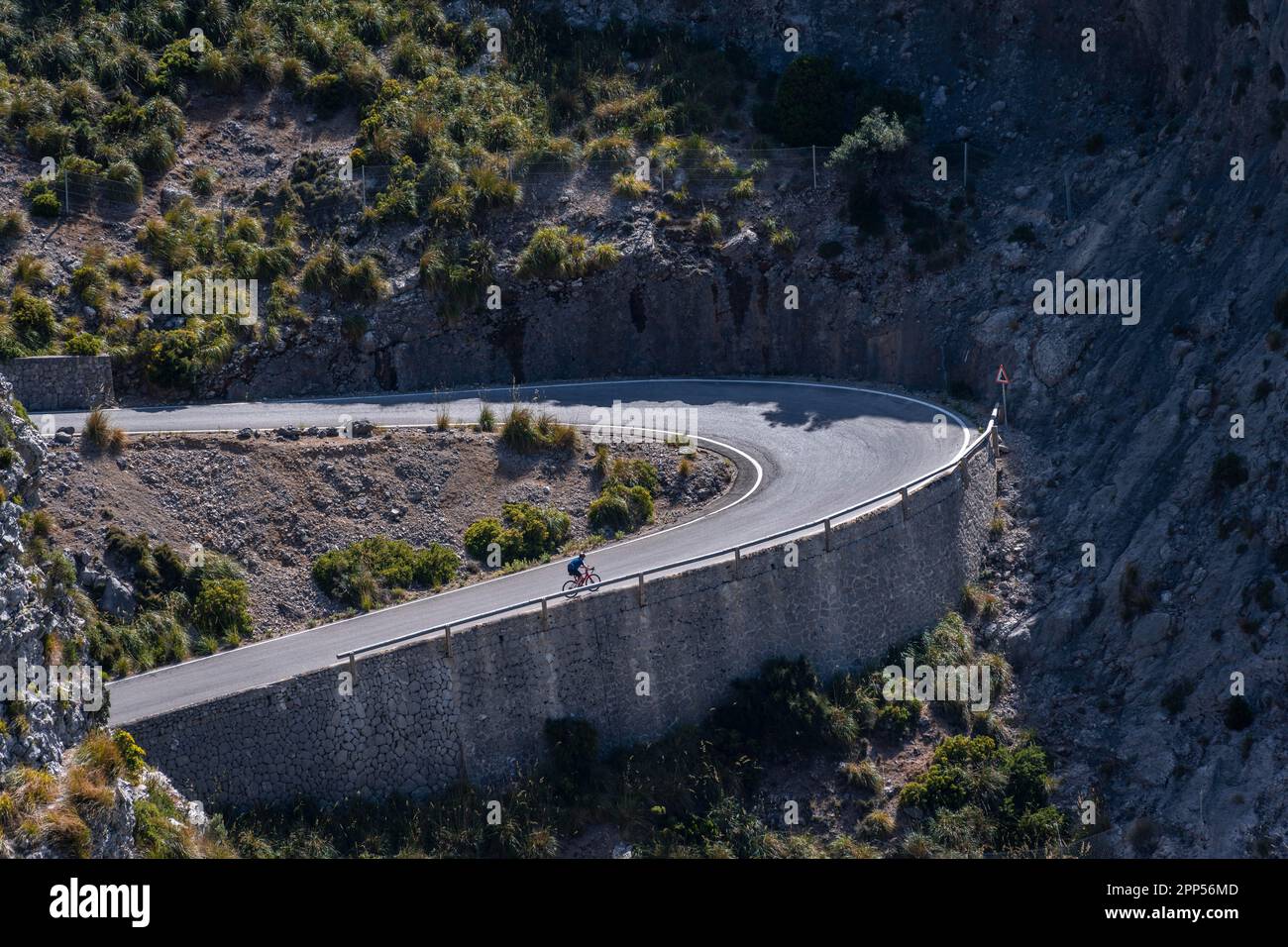 Ciclisti su strada in salita, passo con serpentine a SA Colobra, Serra de Tramuntana, Maiorca, Isole Baleari, Spagna Foto Stock