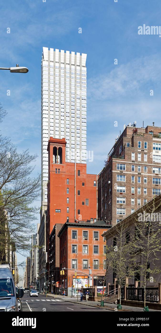 La profonda facciata in mattoni rossi di Morgan Lofts e l'alto colonnato sono un forte contrasto con il cielo e il Langham, sulla 36th Street nella Murray Hill di Manhattan. Foto Stock