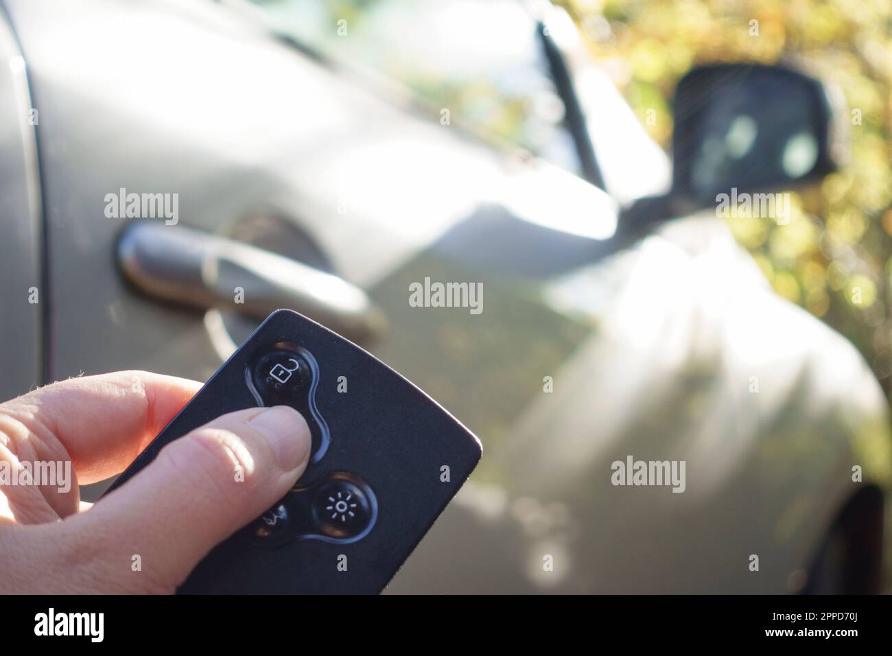 Mano di donna che blocca l'auto con la chiave di carta Foto Stock