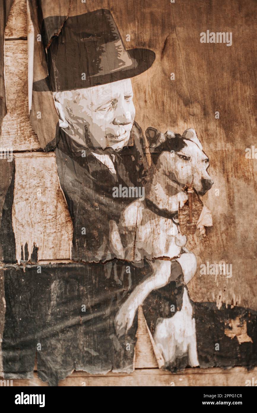 poster a foto sul muro di un uomo con un cane in stile vecchio stile. Foto Stock