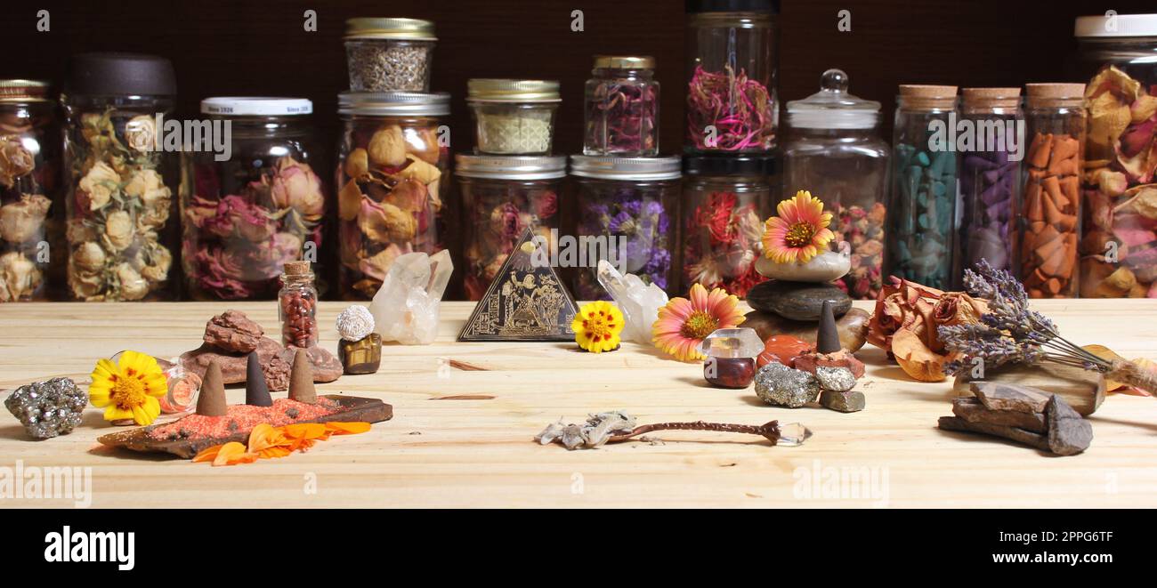 Altare di meditazione con cristalli di roccia e fiori. Vasi di Erbe in background Foto Stock