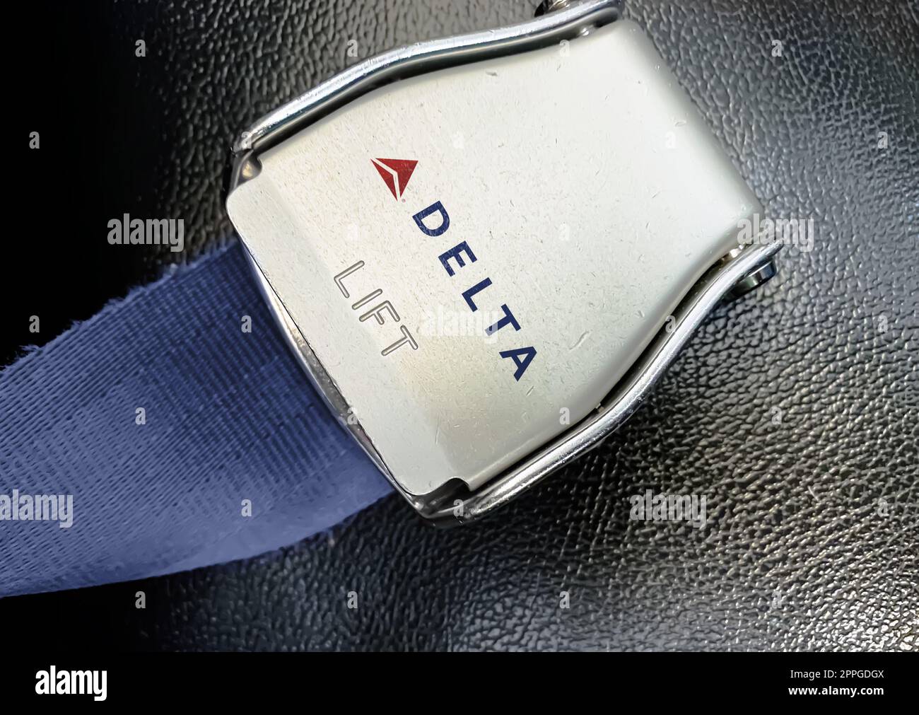 Dettaglio della fibbia della cintura di sicurezza con il logo di Delta Airlines su un sedile vuoto Foto Stock