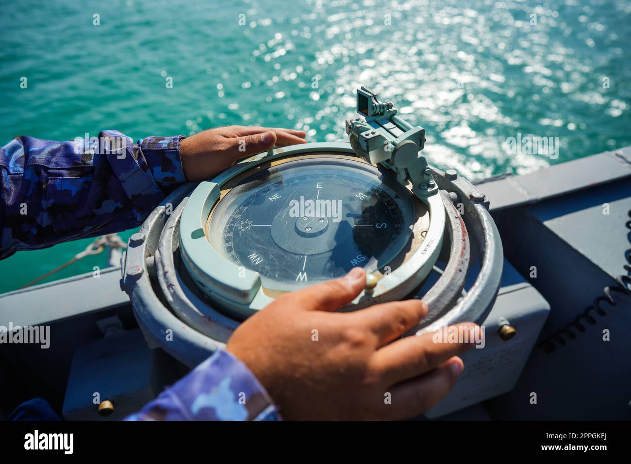 Bussola su una nave militare che naviga sul mare Foto Stock