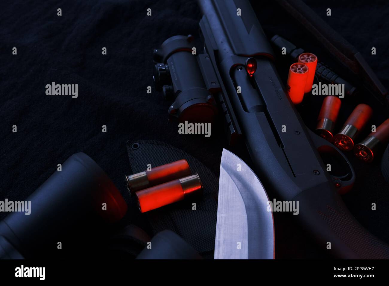 Arma su tela nera: Binocolo, torcia, coltello, fucile, proiettili, vista dall'alto. Vista dall'alto di coltello, fucile, proiettili. Foto Stock