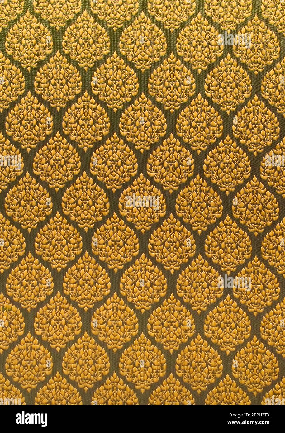 Elegante motivo a ripetizione con filo dorato su una superficie tessile. Primo piano. Foto Stock