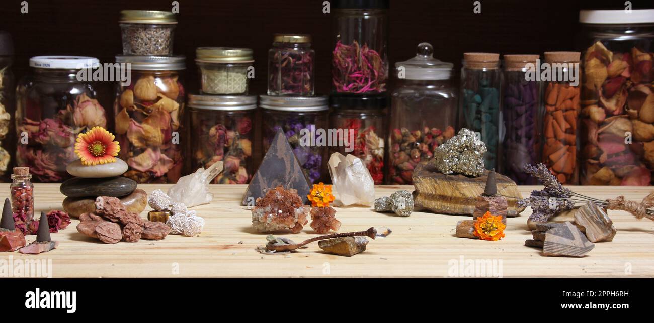 Altare di meditazione con cristalli di roccia e fiori. Vasi di Erbe in background Foto Stock