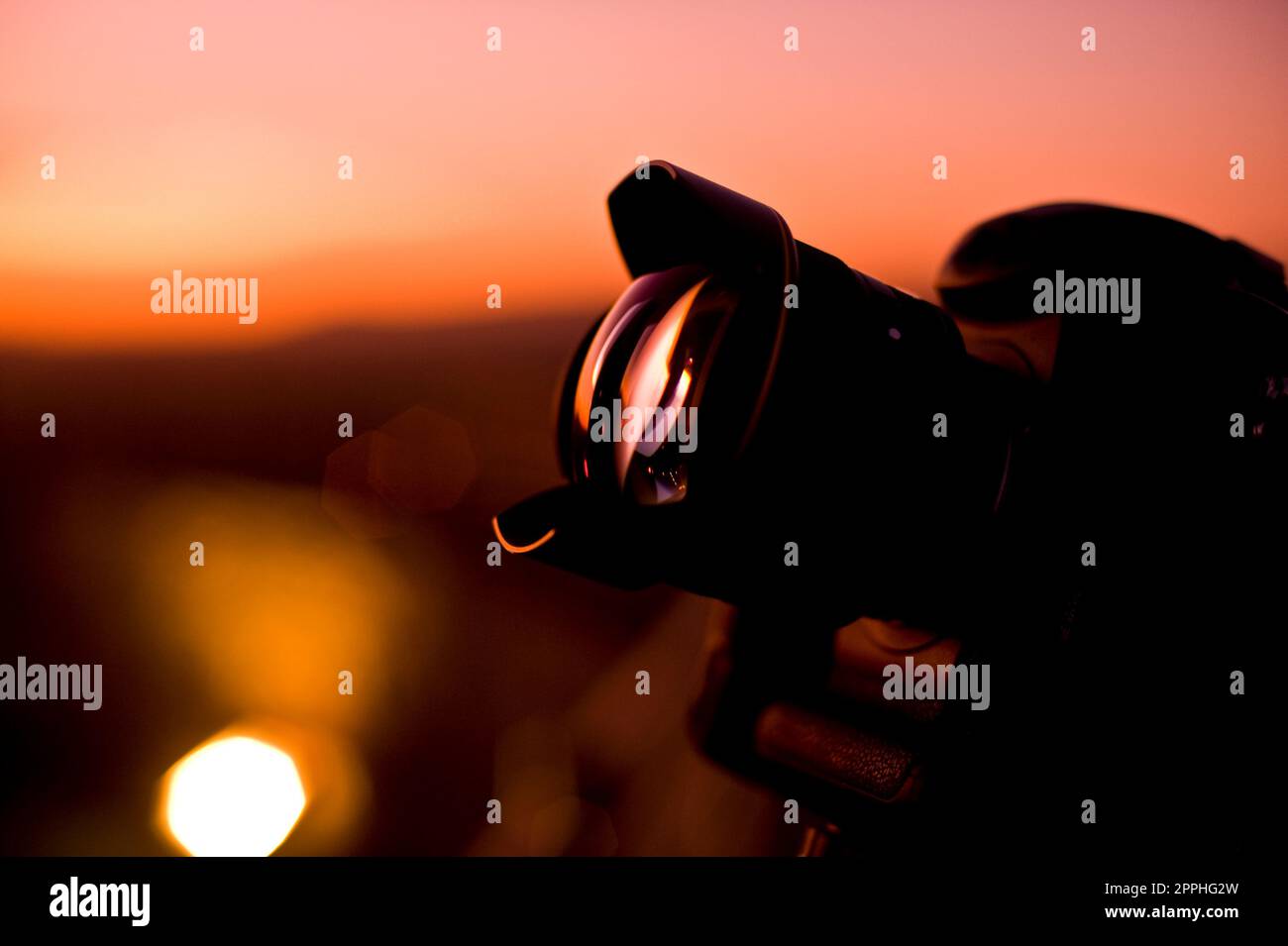 Reflex digitale Nikon con obiettivo da 14 mm che cattura un tramonto. Foto Stock