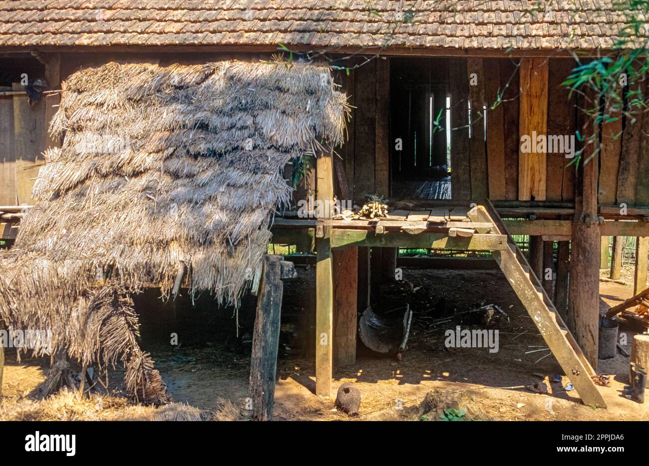 Diapositiva scansionata di una storica fotografia a colori di abitazioni a pile in un villaggio della minoranza etnica del "fiorito Hmong" nel Vietnam del Nord nella Valle del fiume Rosso Foto Stock