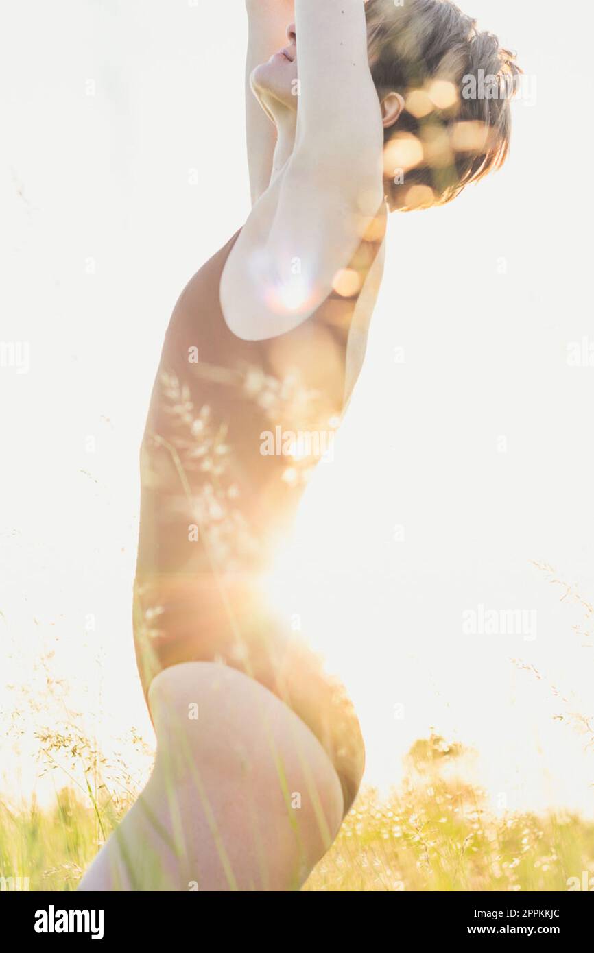 Modello femminile sottile nella fotografia panoramica di erba da campo Foto Stock