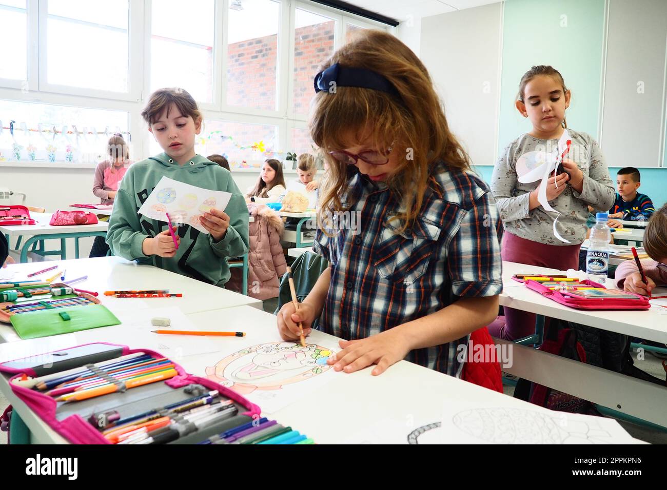 I bambini di 9-10 anni, i ragazzi e le ragazze, fanno artigianato artigianale alla lezione. Standard moderni di istruzione, sviluppo delle capacità creative e abilità motorie eccellenti a scuola 9 aprile 2022 Serbia Srem Foto Stock