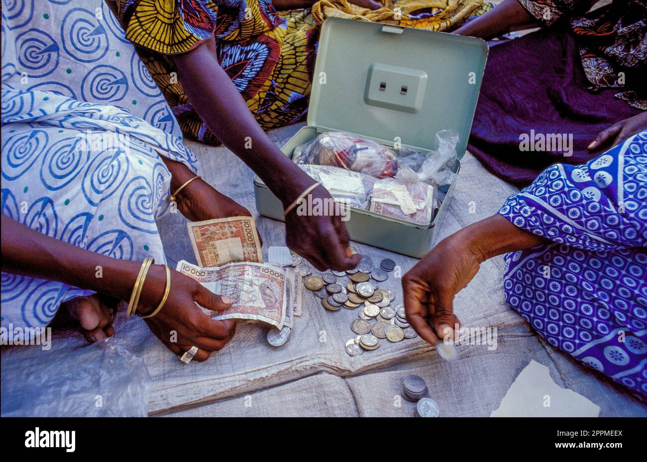 Senegal, le donne contano i soldi che hanno fatto con la loro cooperazione finanziata da un'organizzazione di microcredito fornita da una ONG. Foto Stock