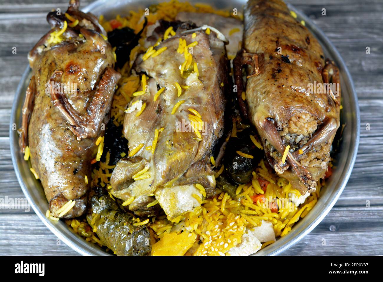 Piccioni di Hamam egiziano Mahshi farcito squab con riso e un gambo di agnello cucinato bene in una casseruola in forno con riso Basmati e roba Foto Stock