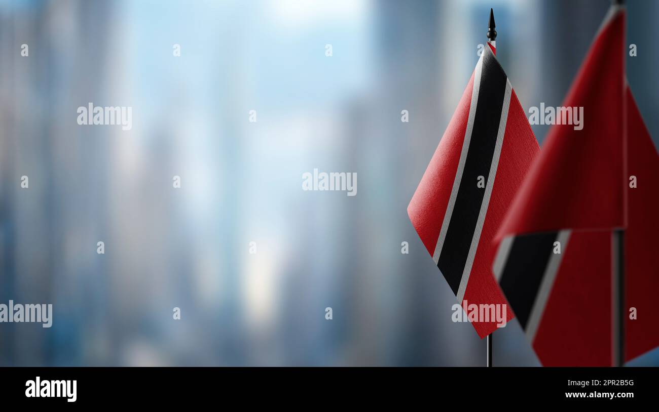Piccole bandiere di Trinidad e Tobago su un astratto sfondo sfocato. Foto Stock