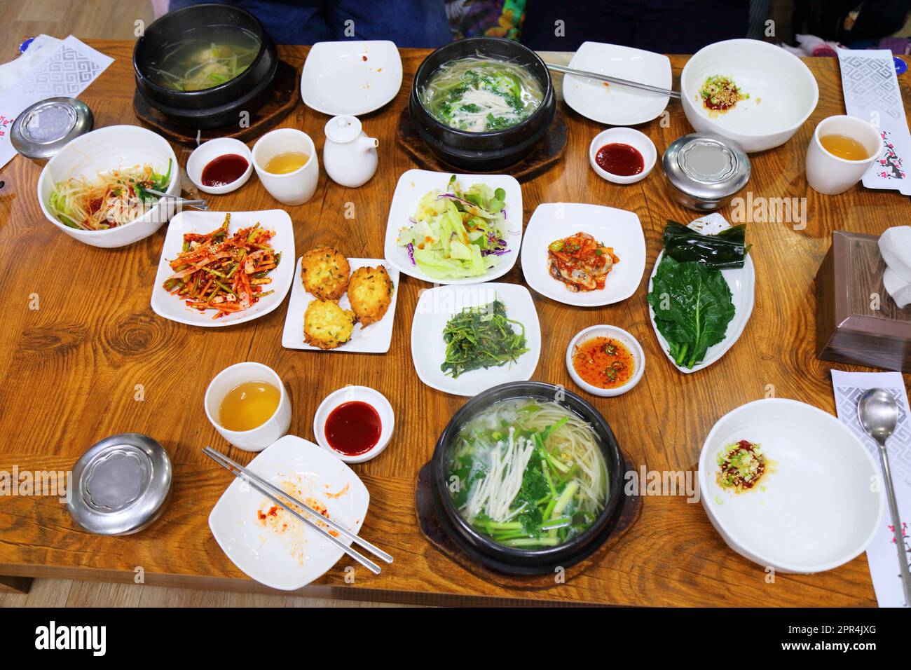 Zuppa di pesce soffusa conosciuta come bokguk in coreano con vari contorni banchan a Busan, Corea del Sud. Foto Stock