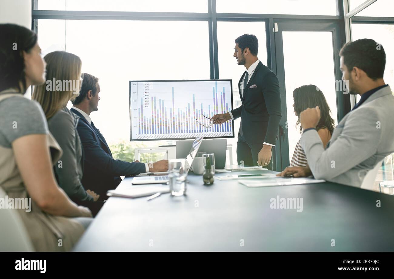 Presentare idee al team. Shot di uomini d'affari aziendali che si incontrano nella sala riunioni. Foto Stock