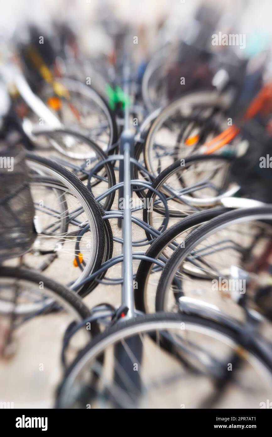 Biciclette - lente sfocata. Una foto sfocata dell'obiettivo di un sacco di biciclette parcheggiate. Utile come sfondo. Foto Stock