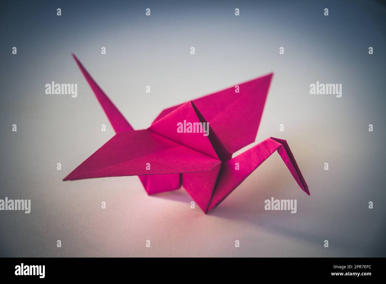 Origami di carta rosa isolato su sfondo bianco Foto Stock