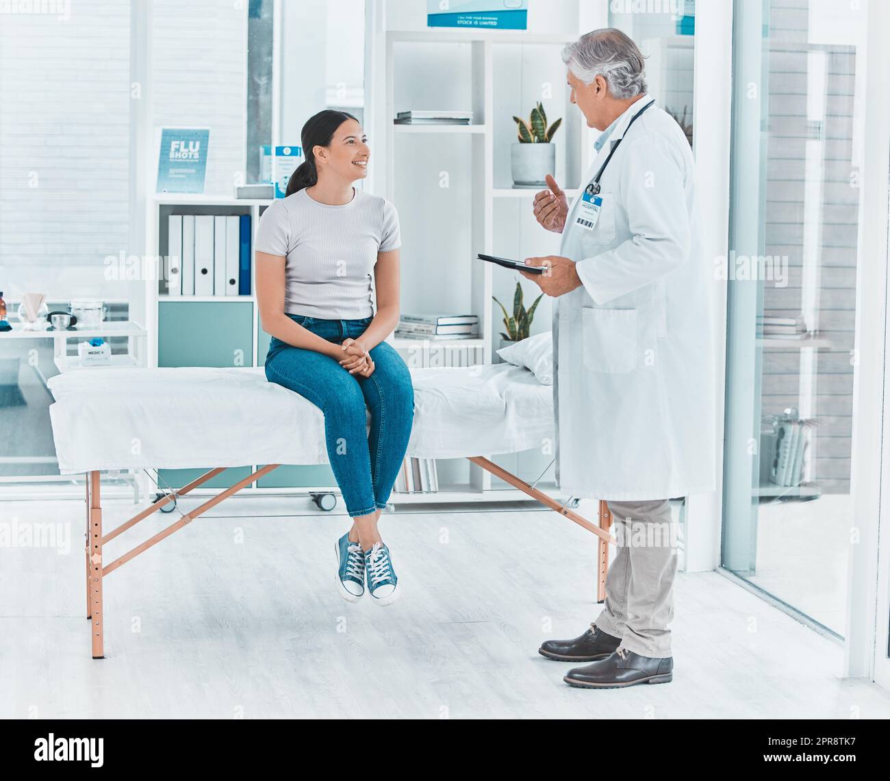Dobbiamo discutere di alcune cose: Un medico che discute i risultati di un paziente con lei utilizzando un tablet digitale. Foto Stock