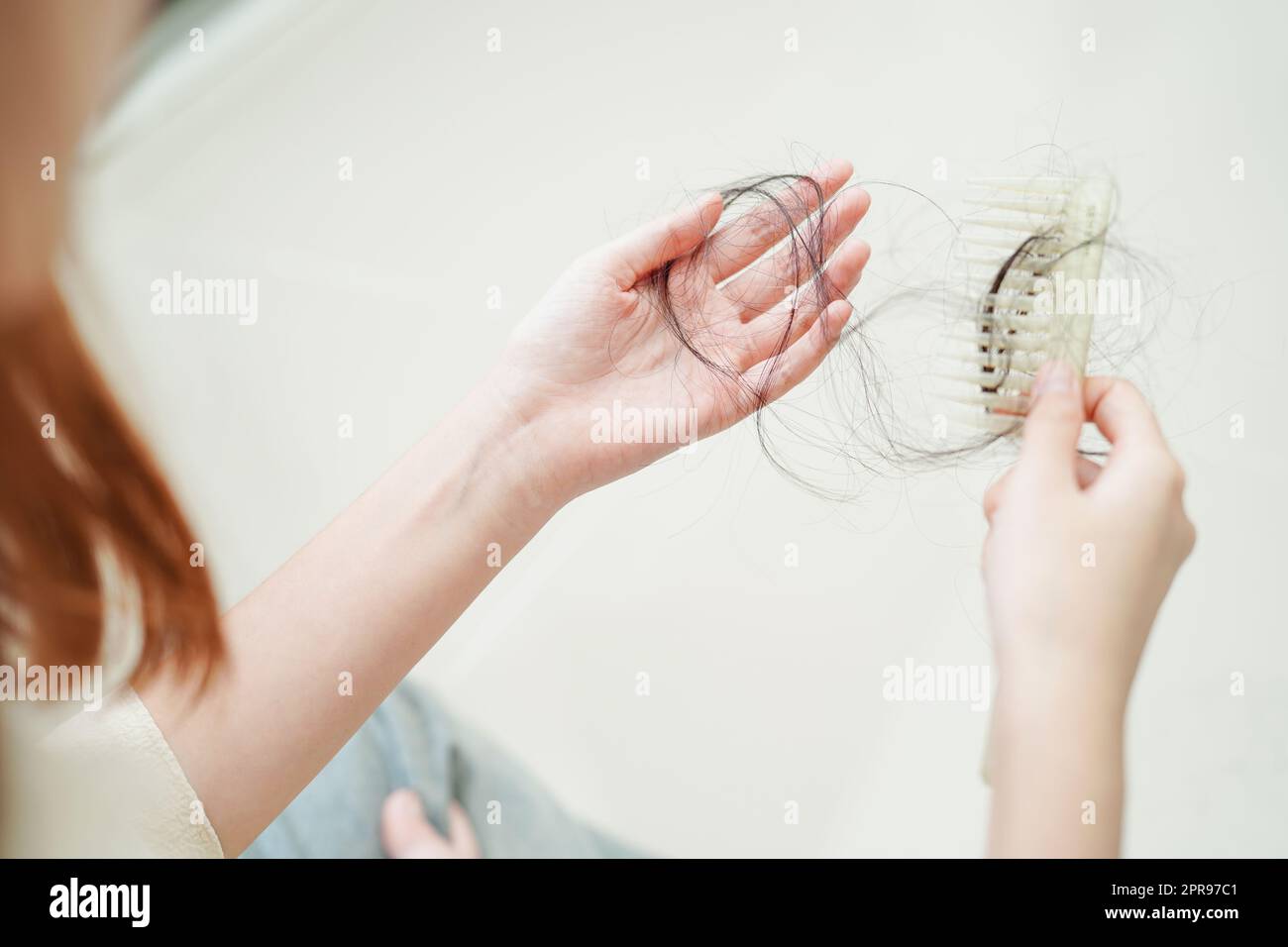 Donna asiatica hanno problemi con la perdita di capelli lungo attaccare in mano. Foto Stock