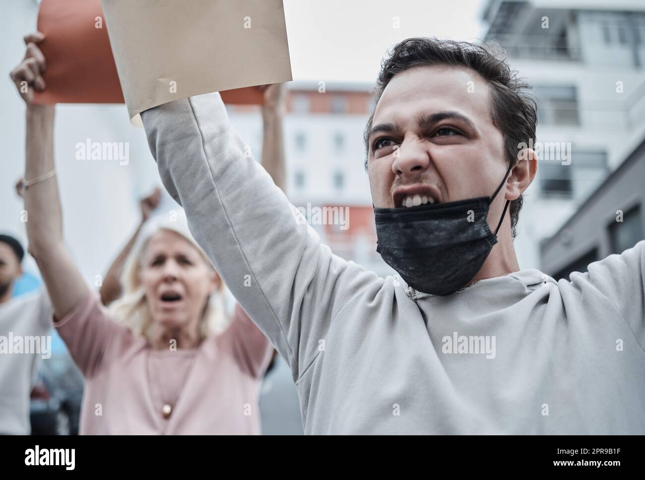 Bene, non permettere mai questo: Un giovane che marciò contro una protesta contro la vaccinazione. Foto Stock