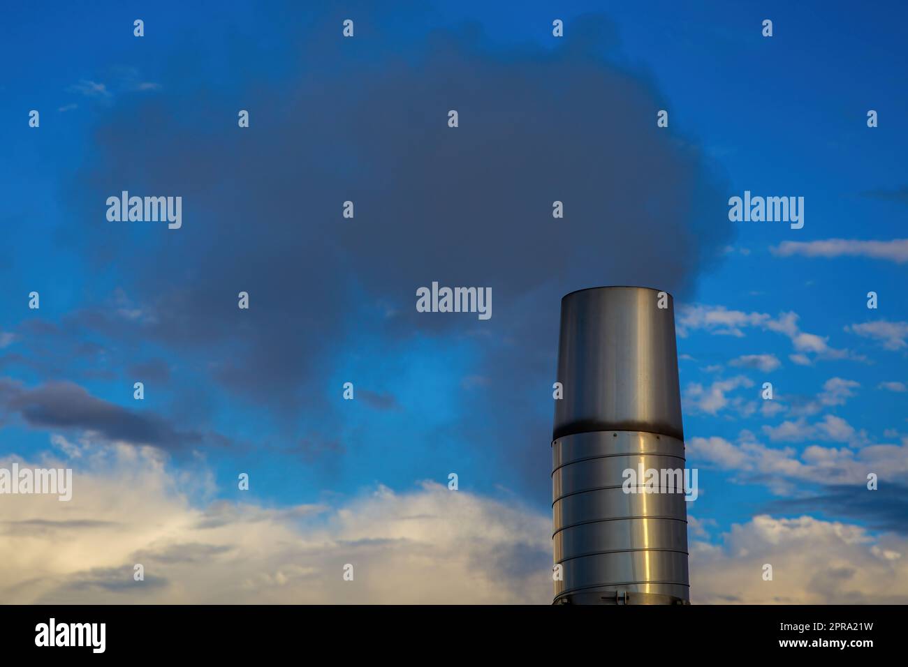 camino fumo inquinamento co2 riscaldamento globale problema ambientale effetto serra blu cielo nuvole Foto Stock