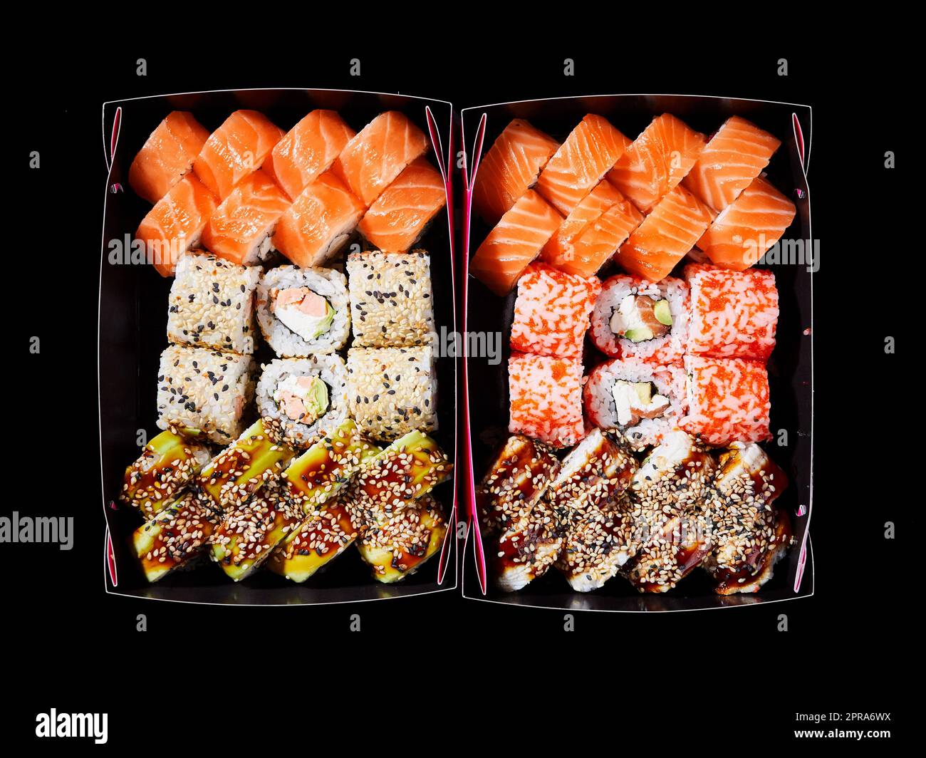 Vista dall'alto del sushi assortito in scatole di cartone pronte per la consegna. Foto Stock