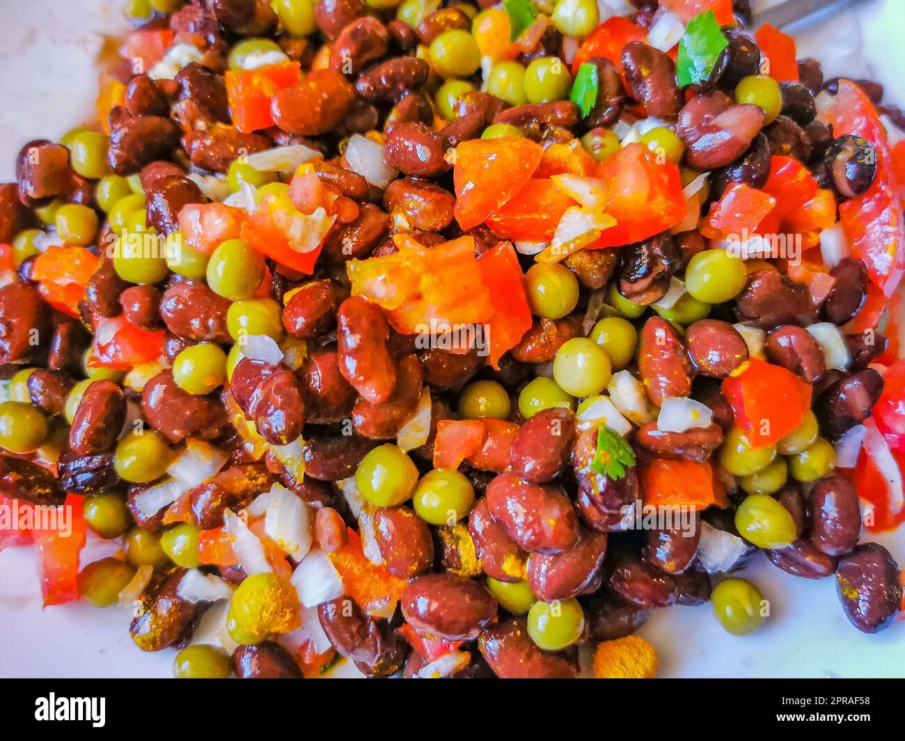 Piatto di verdure con carote piselli cipolle fagioli su piatto bianco. Foto Stock