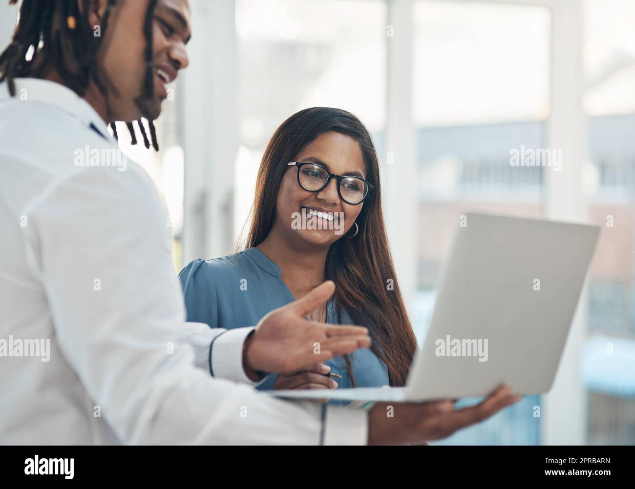 Semplificare le attività per andare avanti. Due uomini d'affari che utilizzano un notebook insieme in ufficio. Foto Stock