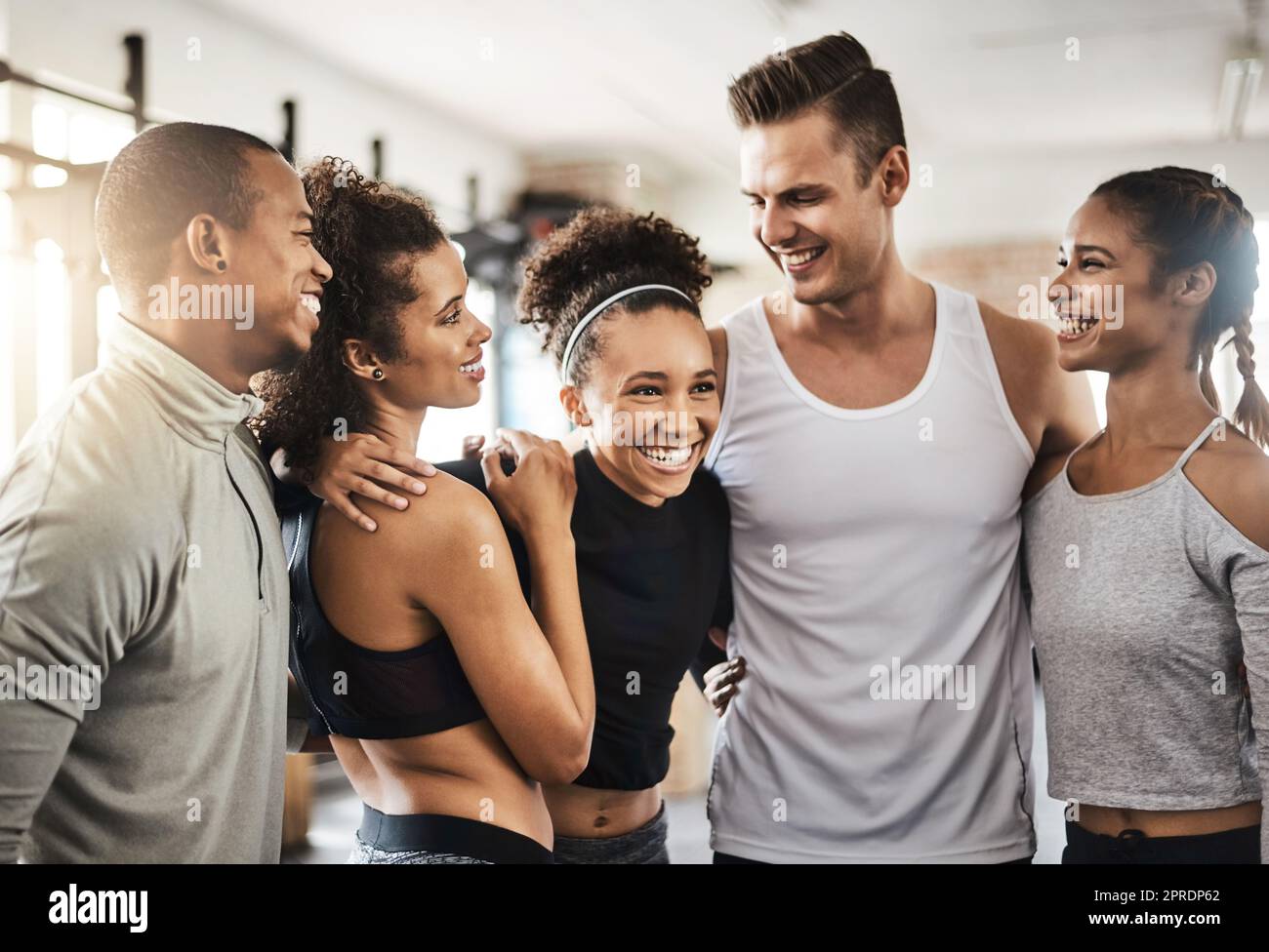 Nessun amico come un compagno di palestra. Un gruppo di giovani felici che si allenano insieme in palestra. Foto Stock