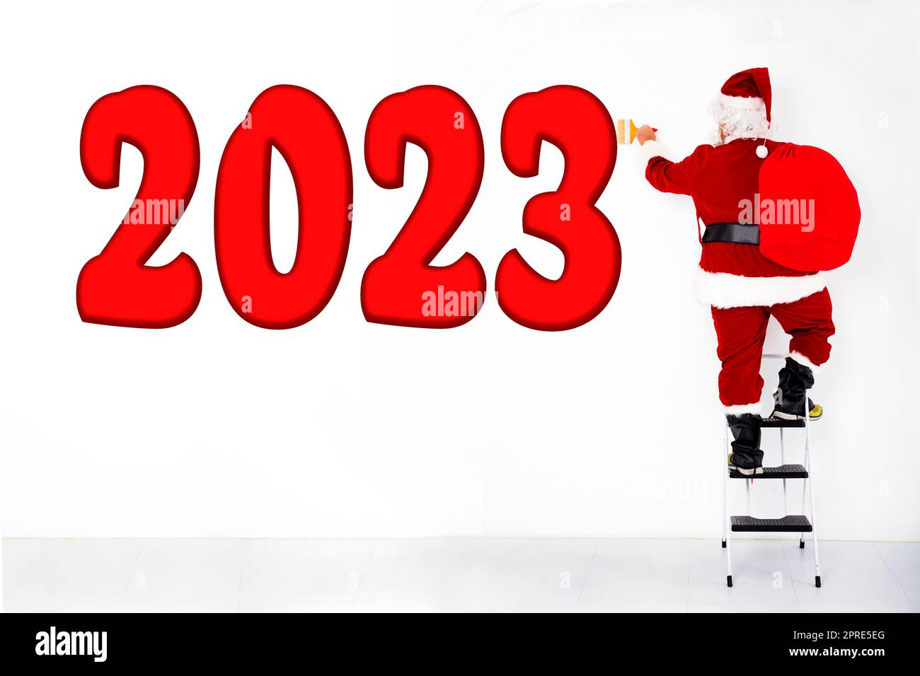 Babbo natale disegnare rosso 2023 nuovo anno sulla parete bianca Foto Stock