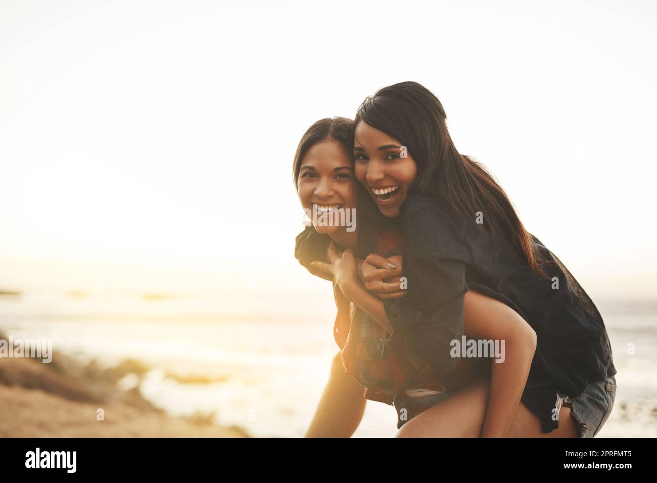 Le giornate estive sono state fatte per giocare: Due giovani donne hanno fatto un giro in spiaggia. Foto Stock